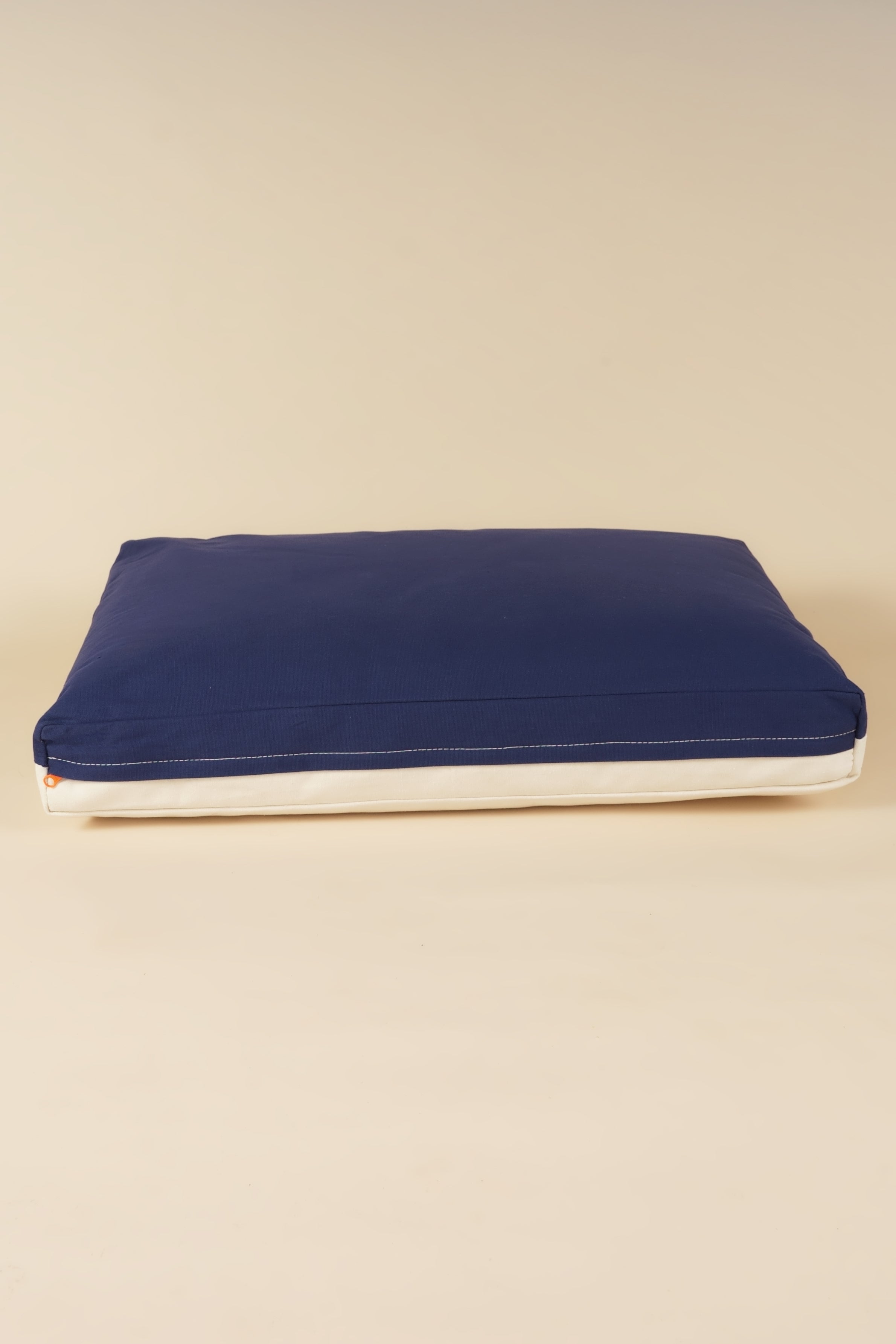 Back view of a premium kapok dog bed in navy and white
