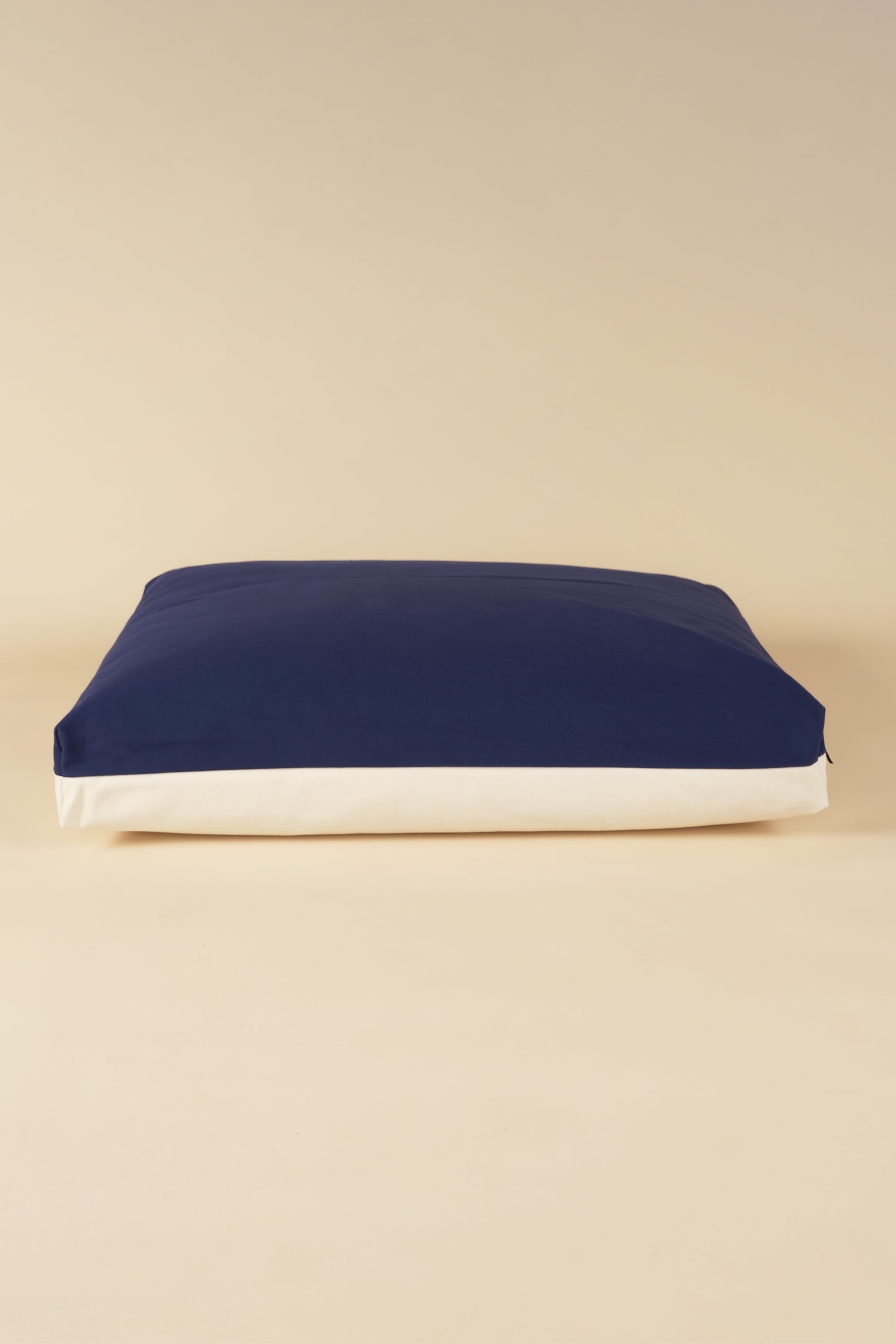 Front view of a premium kapok dog bed in navy and white