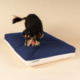 Side view of a premium kapok dog bed in navy and white