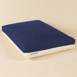 Side view of a premium kapok dog bed in navy and white