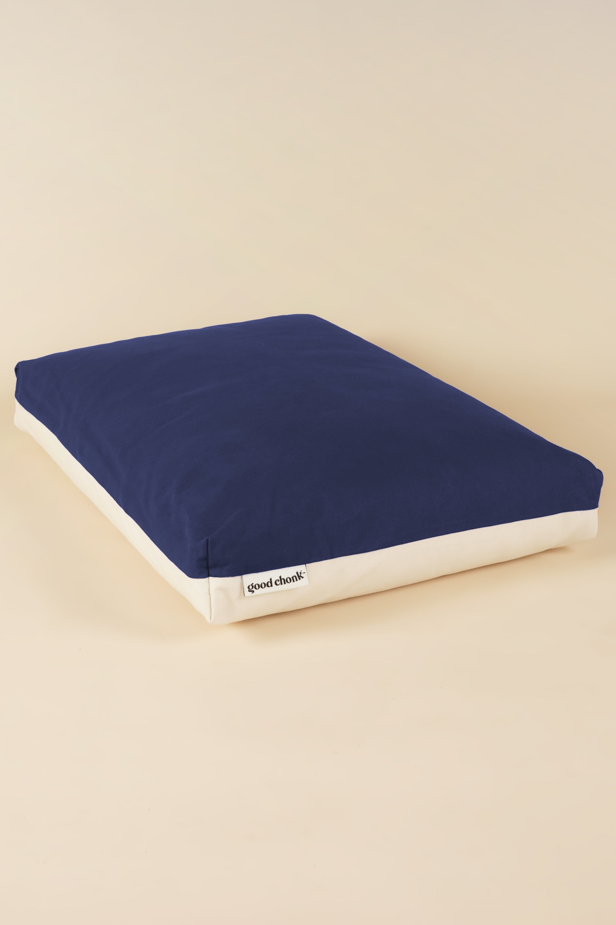 Side view of a premium kapok dog bed in navy and white